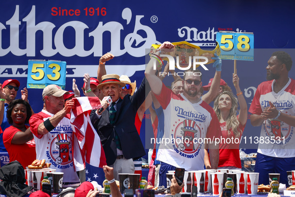 Patrick Bertoletti wins the men's title during Nathan's Famous Hot Dogs Eating Contest which takes place annually at Coney Island on Indepen...