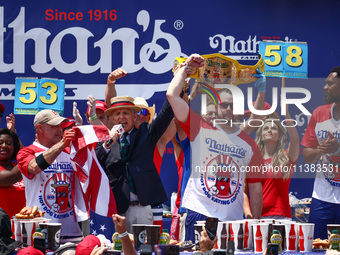 Patrick Bertoletti wins the men's title during Nathan's Famous Hot Dogs Eating Contest which takes place annually at Coney Island on Indepen...