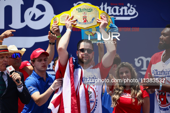 Patrick Bertoletti wins the men's title during Nathan's Famous Hot Dogs Eating Contest which takes place annually at Coney Island on Indepen...