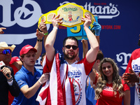 Patrick Bertoletti wins the men's title during Nathan's Famous Hot Dogs Eating Contest which takes place annually at Coney Island on Indepen...