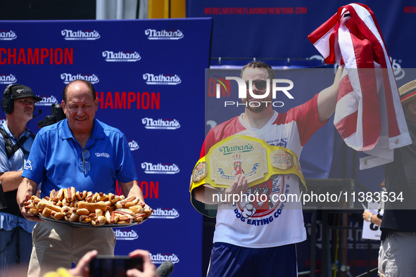 Patrick Bertoletti wins the men's title during Nathan's Famous Hot Dogs Eating Contest which takes place annually at Coney Island on Indepen...