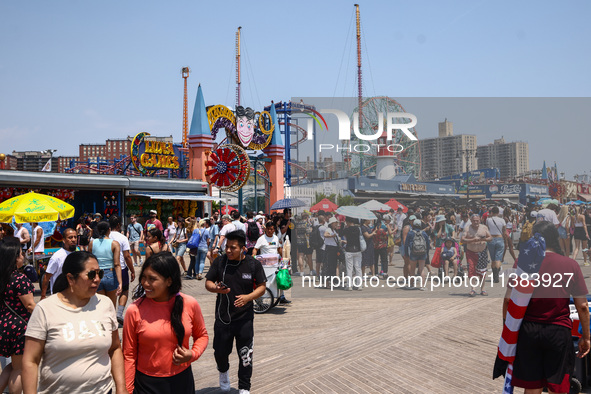 Crowds of people are seen on Riegelmann Boardwalk at Coney Island Beach on Independence Day in New York, United States of America on July 4t...