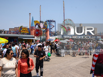 Crowds of people are seen on Riegelmann Boardwalk at Coney Island Beach on Independence Day in New York, United States of America on July 4t...