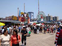 Crowds of people are seen on Riegelmann Boardwalk at Coney Island Beach on Independence Day in New York, United States of America on July 4t...