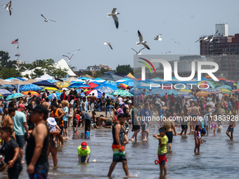 Crowds of people enjoy the beach at Coney Island Beach on Independence Day in New York, United States of America on July 4th, 2024.
 (