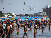 Crowds of people enjoy the beach at Coney Island Beach on Independence Day in New York, United States of America on July 4th, 2024.
 (