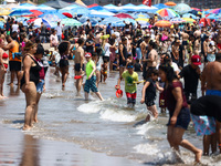 Crowds of people enjoy the beach at Coney Island Beach on Independence Day in New York, United States of America on July 4th, 2024.
 (