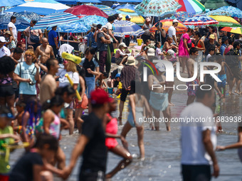 Crowds of people enjoy the beach at Coney Island Beach on Independence Day in New York, United States of America on July 4th, 2024.
 (