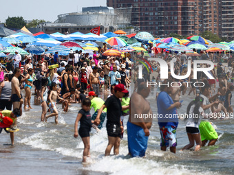 Crowds of people enjoy the beach at Coney Island Beach on Independence Day in New York, United States of America on July 4th, 2024.
 (