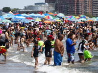 Crowds of people enjoy the beach at Coney Island Beach on Independence Day in New York, United States of America on July 4th, 2024.
 (