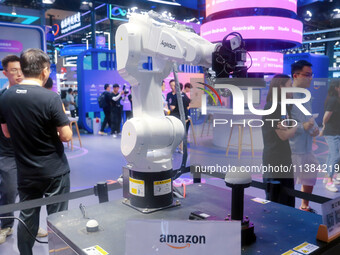 Visitors are viewing a non-human robot at Amazon's booth at the WAIC World Artificial Intelligence Conference in Shanghai, China, on July 4,...