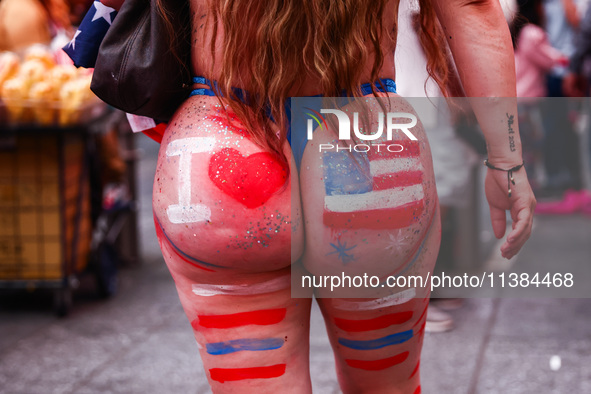 A woman on Times Square on Independence Day In New York, United States on America on July 4th, 2024.
 