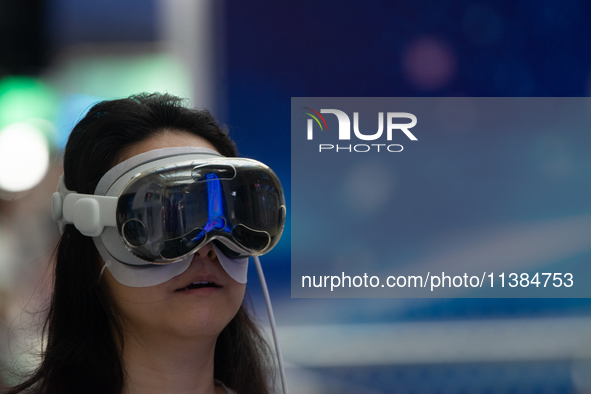 A visitor is wearing a Virtual Reality headset at the World Artificial Intelligence Conference at the Shanghai World Expo Exhibition Center...