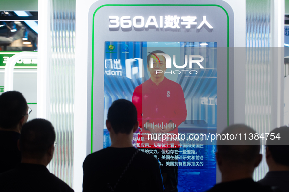 Visitors are interacting with a digital human at the Zhou Hongyi stand at the World Artificial Intelligence Conference at the Shanghai World...