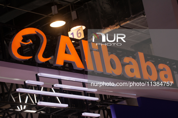 The logo of Alibaba is being seen at the Alibaba stand at the World Artificial Intelligence Conference at the Shanghai World Expo Exhibition...