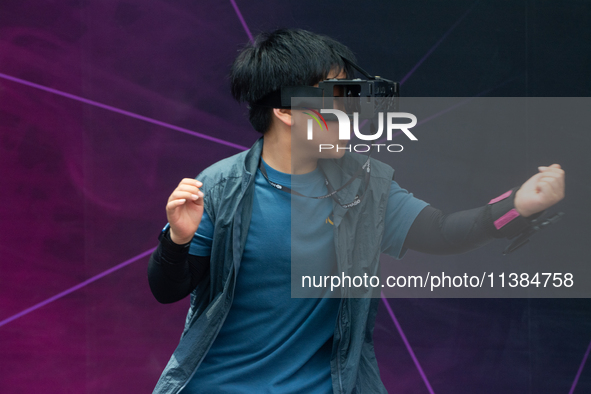 A young visitor is playing games with a Virtual Reality headset at the World Artificial Intelligence Conference at the Shanghai World Expo E...