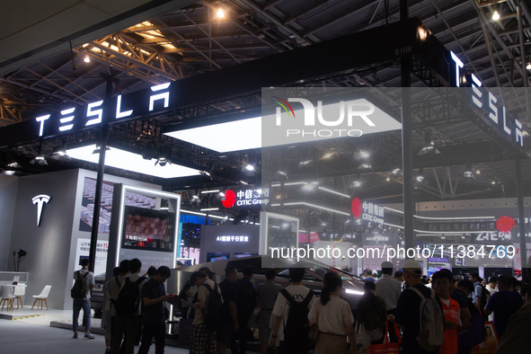 Visitors are visiting the Tesla stand at the World Artificial Intelligence Conference at the Shanghai World Expo Exhibition Center in Shangh...