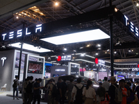 Visitors are visiting the Tesla stand at the World Artificial Intelligence Conference at the Shanghai World Expo Exhibition Center in Shangh...