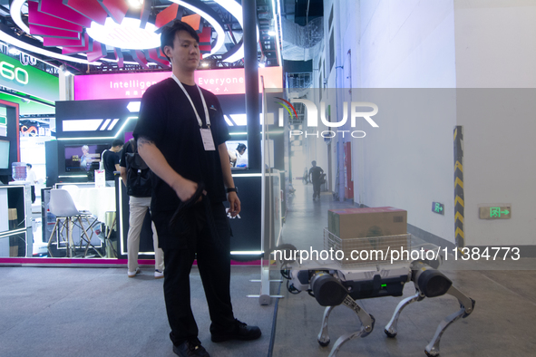 The robot dog is carrying a pack of water at the World Artificial Intelligence Conference at the Shanghai World Expo Exhibition Center in Sh...