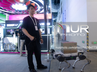 The robot dog is carrying a pack of water at the World Artificial Intelligence Conference at the Shanghai World Expo Exhibition Center in Sh...