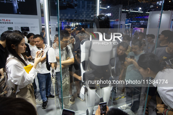 Visitors are taking pictures of the second-generation Optimus Humanoid Robot at the Tesla stand at the World Artificial Intelligence Confere...