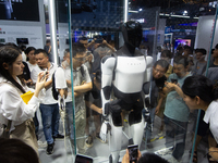 Visitors are taking pictures of the second-generation Optimus Humanoid Robot at the Tesla stand at the World Artificial Intelligence Confere...