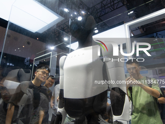 Visitors are taking pictures of the second-generation Optimus Humanoid Robot at the Tesla stand at the World Artificial Intelligence Confere...