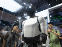 Visitors are taking pictures of the second-generation Optimus Humanoid Robot at the Tesla stand at the World Artificial Intelligence Confere...