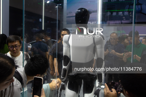 Visitors are taking pictures of the second-generation Optimus Humanoid Robot at the Tesla stand at the World Artificial Intelligence Confere...