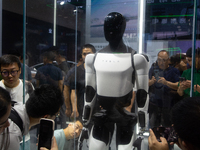 Visitors are taking pictures of the second-generation Optimus Humanoid Robot at the Tesla stand at the World Artificial Intelligence Confere...