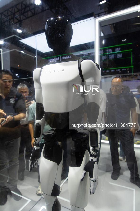 Visitors are taking pictures of the second-generation Optimus Humanoid Robot at the Tesla stand at the World Artificial Intelligence Confere...