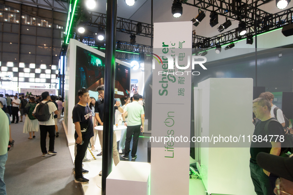 Visitors are visiting the Schelder Electric stand at the World Artificial Intelligence Conference at the Shanghai World Expo Exhibition Cent...