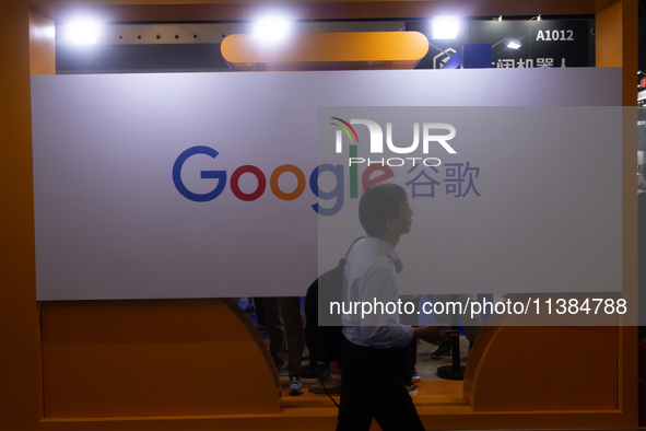 A visitor is walking past a Google sign at the World Artificial Intelligence Conference at the Shanghai World Expo Exhibition Center in Shan...