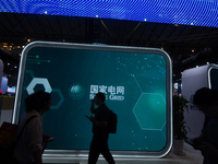 Visitors are visiting the China State Grid stand at the World Artificial Intelligence Conference at the Shanghai World Expo Exhibition Cente...