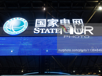 The logo of China State Grid is being seen at the World Artificial Intelligence Conference at the Shanghai World Expo Exhibition Center in S...