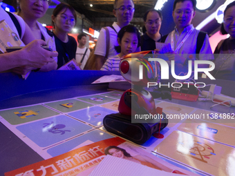 A small robot is being used for children learning at the World Artificial Intelligence Conference at the Shanghai World Expo Exhibition Cent...