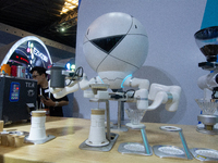 A robot for making coffee is being displayed at the World Artificial Intelligence Conference at the Shanghai World Expo Exhibition Center in...