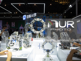 Children are playing at Hai Tun Zixi, a learning assistant AI, standing at the World Artificial Intelligence Conference at the Shanghai Worl...