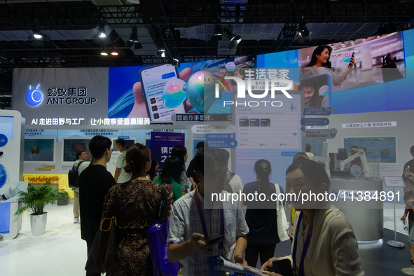 Visitors are visiting the Ant Group stand at the World Artificial Intelligence Conference at the Shanghai World Expo Exhibition Center in Sh...