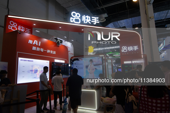 Visitors are being seen at the Kwai app stand at the World Artificial Intelligence Conference at the Shanghai World Expo Exhibition Center i...