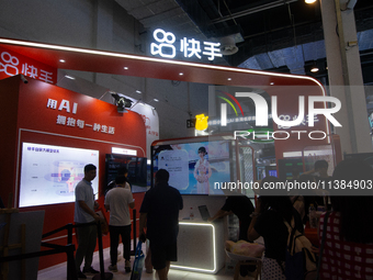 Visitors are being seen at the Kwai app stand at the World Artificial Intelligence Conference at the Shanghai World Expo Exhibition Center i...