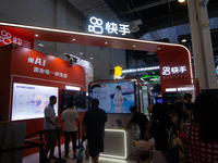 Visitors are being seen at the Kwai app stand at the World Artificial Intelligence Conference at the Shanghai World Expo Exhibition Center i...