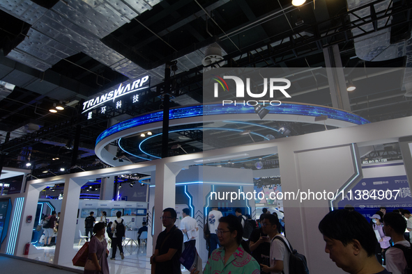 Visitors are being seen at the Transwarp stand at the World Artificial Intelligence Conference at the Shanghai World Expo Exhibition Center...