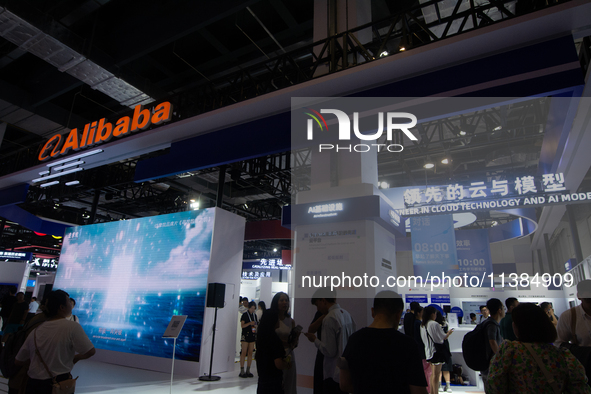 Visitors are being seen at the Alibaba stand at the World Artificial Intelligence Conference at the Shanghai World Expo Exhibition Center in...