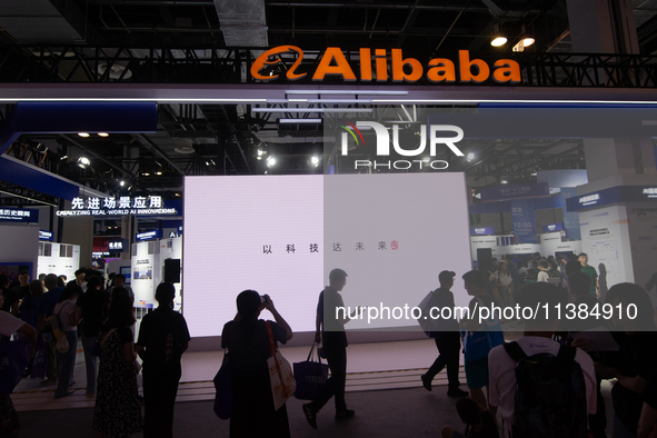 Visitors are being seen at the Alibaba stand at the World Artificial Intelligence Conference at the Shanghai World Expo Exhibition Center in...