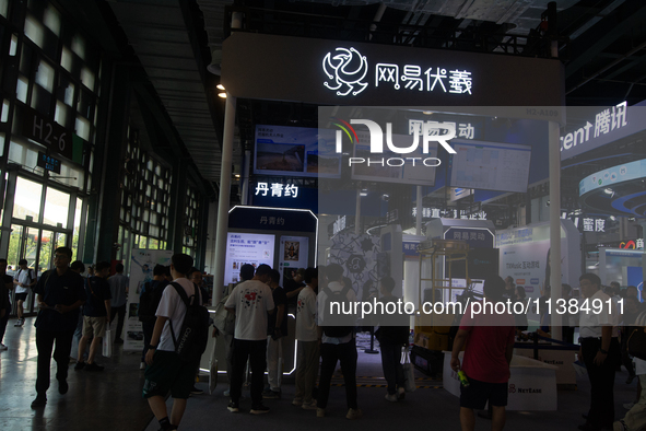 Visitors are being seen at the Netease stand at the World Artificial Intelligence Conference at the Shanghai World Expo Exhibition Center in...