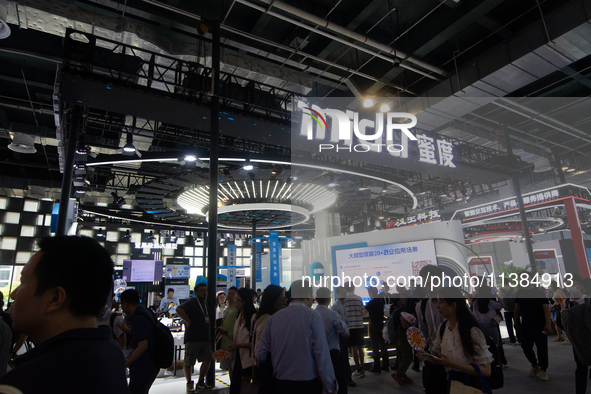 Visitors are being seen at the Midu stand at the World Artificial Intelligence Conference at the Shanghai World Expo Exhibition Center in Sh...