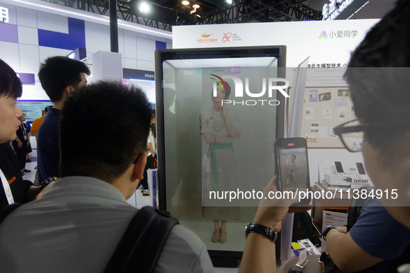 Visitors are interacting with a digital human at the World Artificial Intelligence Conference at the Shanghai World Expo Exhibition Center i...