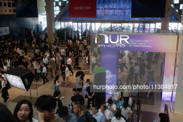 A crowd of visitors is being seen at the World Artificial Intelligence Conference at the Shanghai World Expo Exhibition Center in Shanghai,...