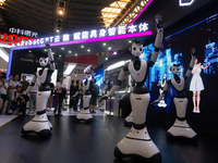 Several humanoid robots are performing dance movements at the World Artificial Intelligence Conference at the Shanghai World Expo Exhibition...